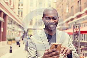 Happy smiling urban professional man using smart phone