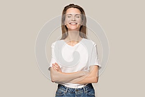 Happy smiling woman with arms crossed laughing at joke