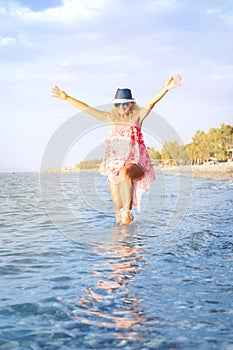 Happy smiling woman in bikini having fun in sea