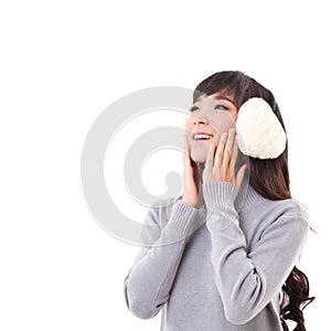 Happy, smiling, woman with earmuffs looking up