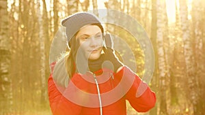 Happy Smiling Woman Enjoying Nature. Standing in autumn park. Young pretty female smiling at camera