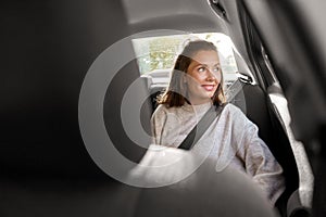 happy smiling woman or female passenger in car