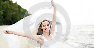 Happy smiling woman in free happiness bliss on ocean beach standing with open hands. Portrait of a multicultural female