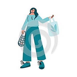 Happy smiling woman in green shirt stands with eco bags of healthy food. Vector illustration in cartoon style.