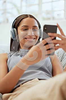 Happy, smiling woman listening and browsing music on her phone during a break at work. Business woman enjoying some free