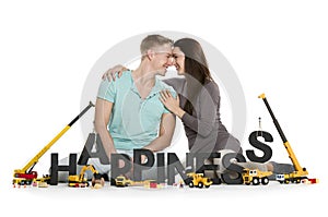 Happy smiling woman and man building happiness-word.