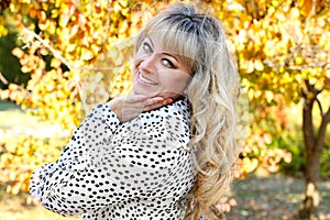Happy smiling woman over autumn leaves