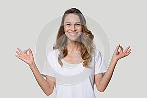 Happy smiling woman practicing yoga, meditating, breathing, stress relief photo