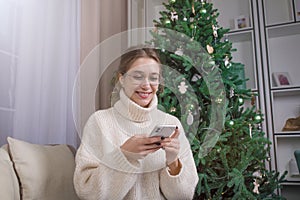 Happy smiling woman received newsletter on mobile phone