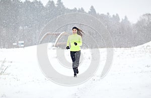 Happy smiling woman running outdoors in winter