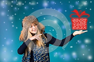 Happy smiling woman showing pointing on box with discounts 50%, 30%, 20%. Winter sale concept.