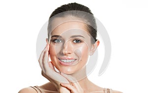 Happy smiling woman touching her flawless glowy fresh clean facial skin, portrait. Healthcare, wellness, beauty treatment and