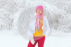 Happy smiling woman wearing a colorful clothes in snowy winter