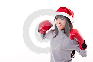 Happy, smiling woman wearing X'mas santa hat, boxing gloves