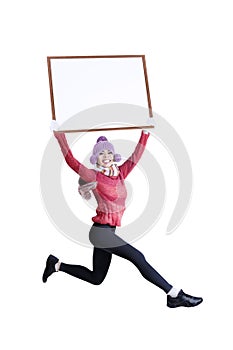 Happy smiling woman in winter clothing holding blank board - isolated