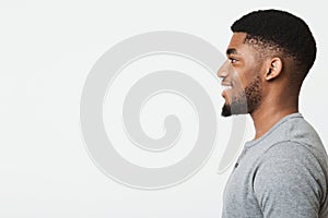 Happy smiling young african-american man profile portrait