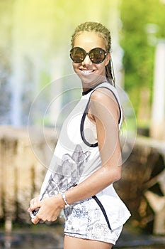 Happy Smiling Young African American Teenager Girl With Plenty of Dreadlocks Posing in Park