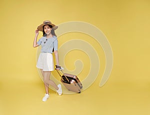 Happy smiling young Asian tourist woman holding passport ticket and luggage going to travel on summer holidays