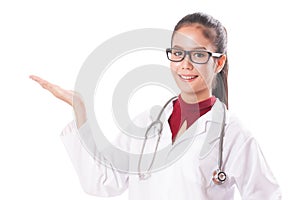 Happy smiling young beautiful female doctor showing blank area for sign