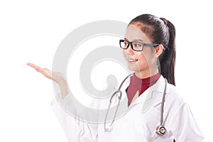 Happy smiling young beautiful female doctor showing blank area for sign