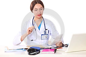 Happy smiling young beautiful female doctor showing blank area for sign or copyspace, over white background