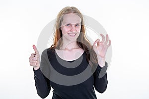 Happy smiling young beautiful pretty cute woman with finger okay gesture showing thumb up sign on white background