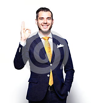 Happy smiling young business man with thumbs up gesture