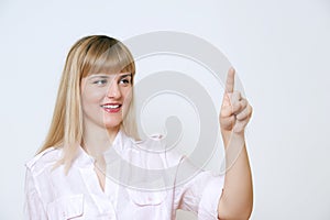 Happy smiling young business woman showing blank area for sign o