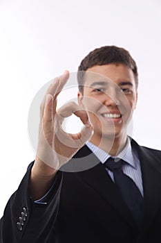 Happy smiling young businessman with okay gesture,