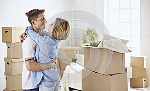 Happy smiling young couple showing a pair of keys of their new house