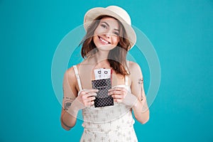 Happy smiling young girl holding passport and travelling tickets