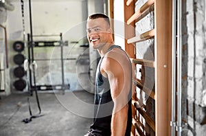 Happy smiling young man in gym