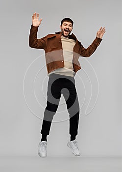 Happy smiling young man jumping in air