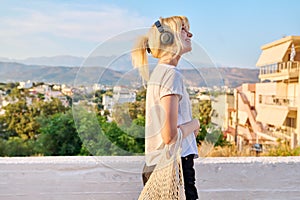 Happy smiling young teenage woman enjoying nature, summer, sunset, vacation