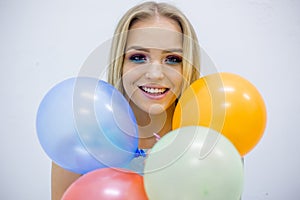 Happy smiling young woman with colorful balloons