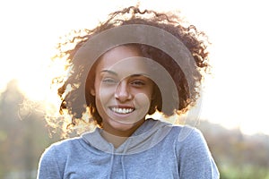 Happy smiling young woman with curly hair