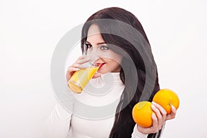 Happy smiling young woman drinking orange juice