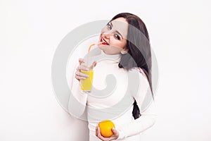 Happy smiling young woman drinking orange juice