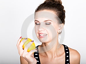 Happy smiling young woman holding fresh juicy lemons. Healthy eating, fruits and vegetables.