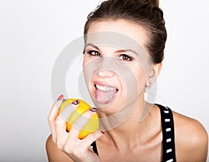 Happy smiling young woman holding fresh juicy lemons. Healthy eating, fruits and vegetables.