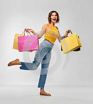 Happy smiling young woman with shopping bags