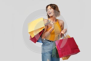 Happy smiling young woman with shopping bags