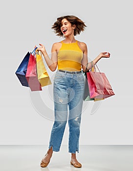 Happy smiling young woman with shopping bags