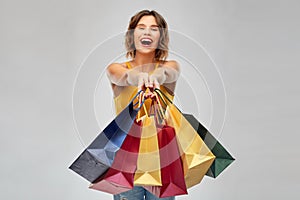 Happy smiling young woman with shopping bags