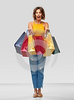 Happy smiling young woman with shopping bags