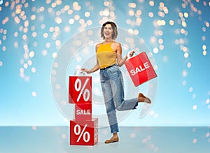 Happy smiling young woman with shopping bags