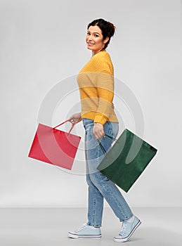 Happy smiling young woman with shopping bags