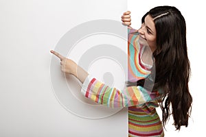 Happy smiling young woman showing blank signboard.