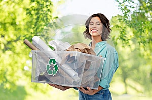 Happy smiling young woman sorting paper waste