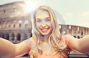 Happy smiling young woman taking selfie